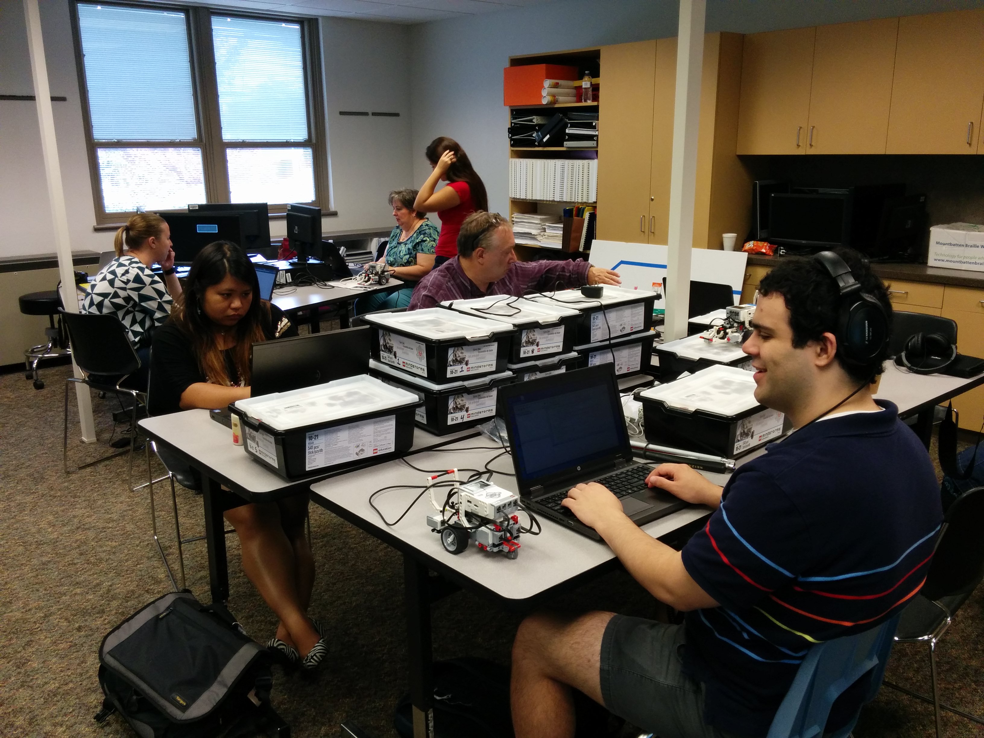 This is a 
            picture of several people at the Experience Programming conference working.